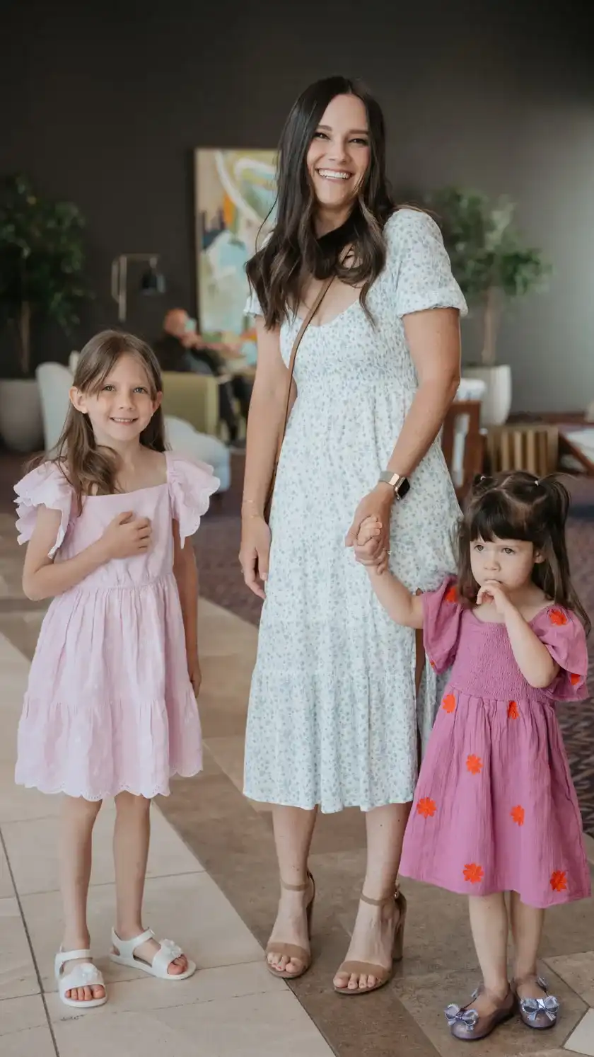 Mother smiling with her two young daughters at Believer Church