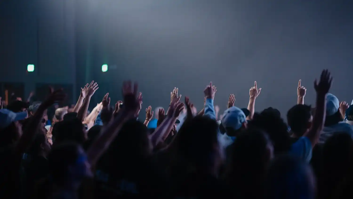 Congregation raising their hands together during worship