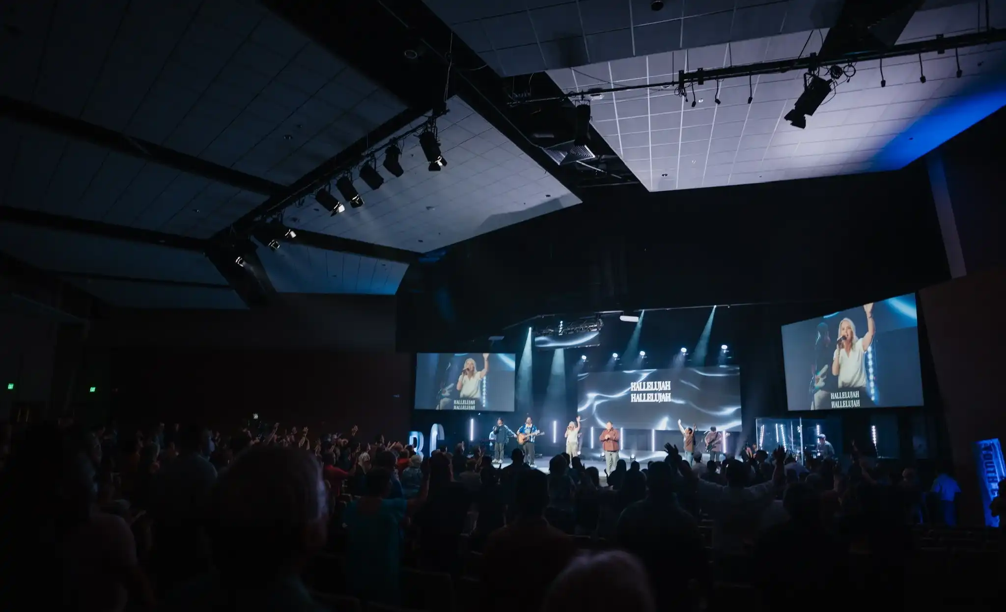 Congregation worshipping in the Believer Church auditorium