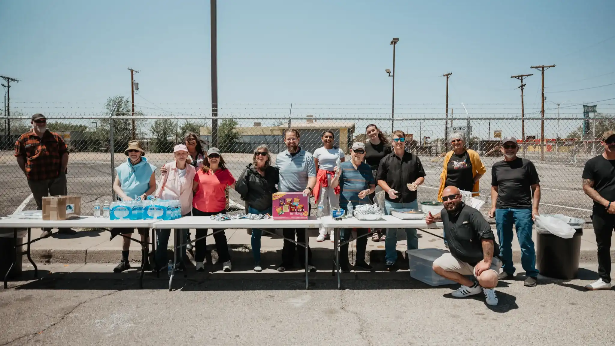 Love ABQ serve team gathered behind tables of food and water