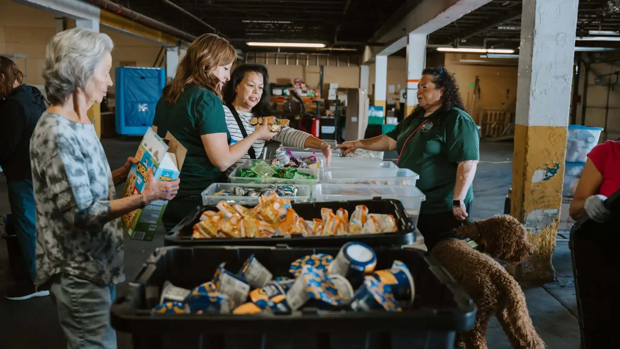 Serve team members handing out food and groceries at a Feed New Mexico Kids distribution