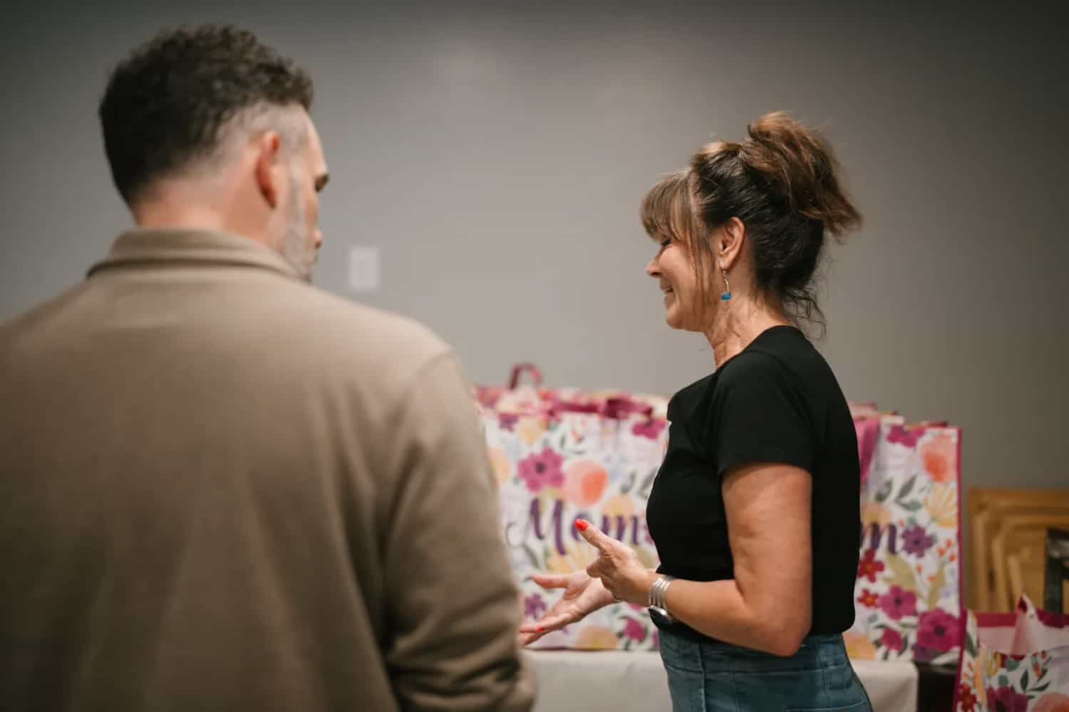 A For The One team member talking with a man at a Believer Church outreach event