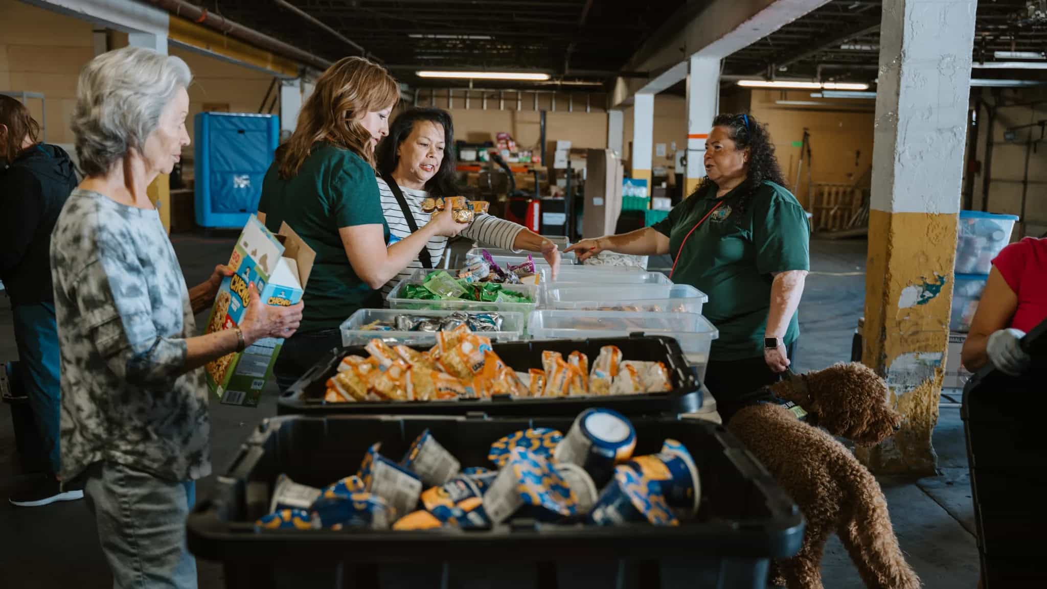 Serve team members handing out food and groceries at a Feed New Mexico Kids distribution